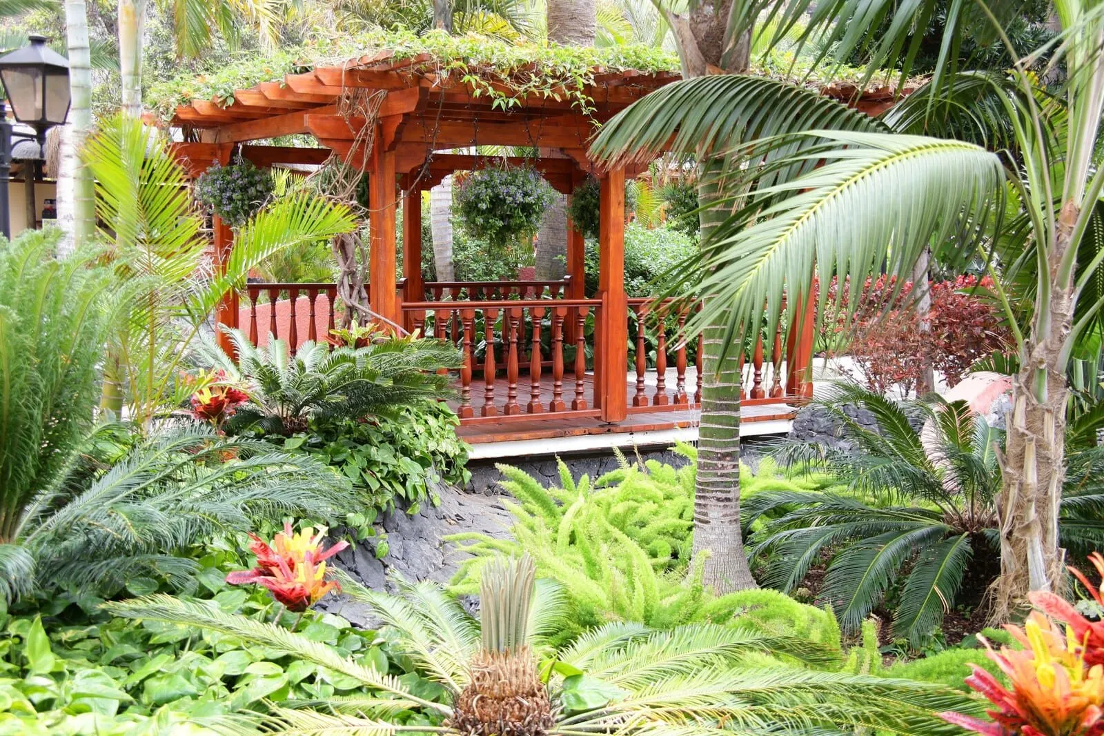 Bahia Principe Explore San Felipe: A wooden gazebo surrounded by lush tropical plants and a stone pathway