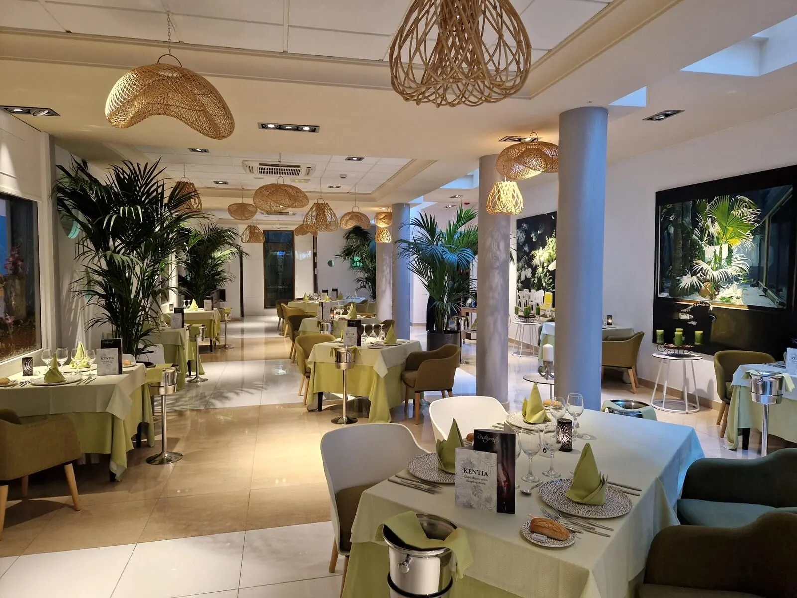 Marylanza Suites & Spa: A restaurant with tables set for dining, hanging wicker light fixtures