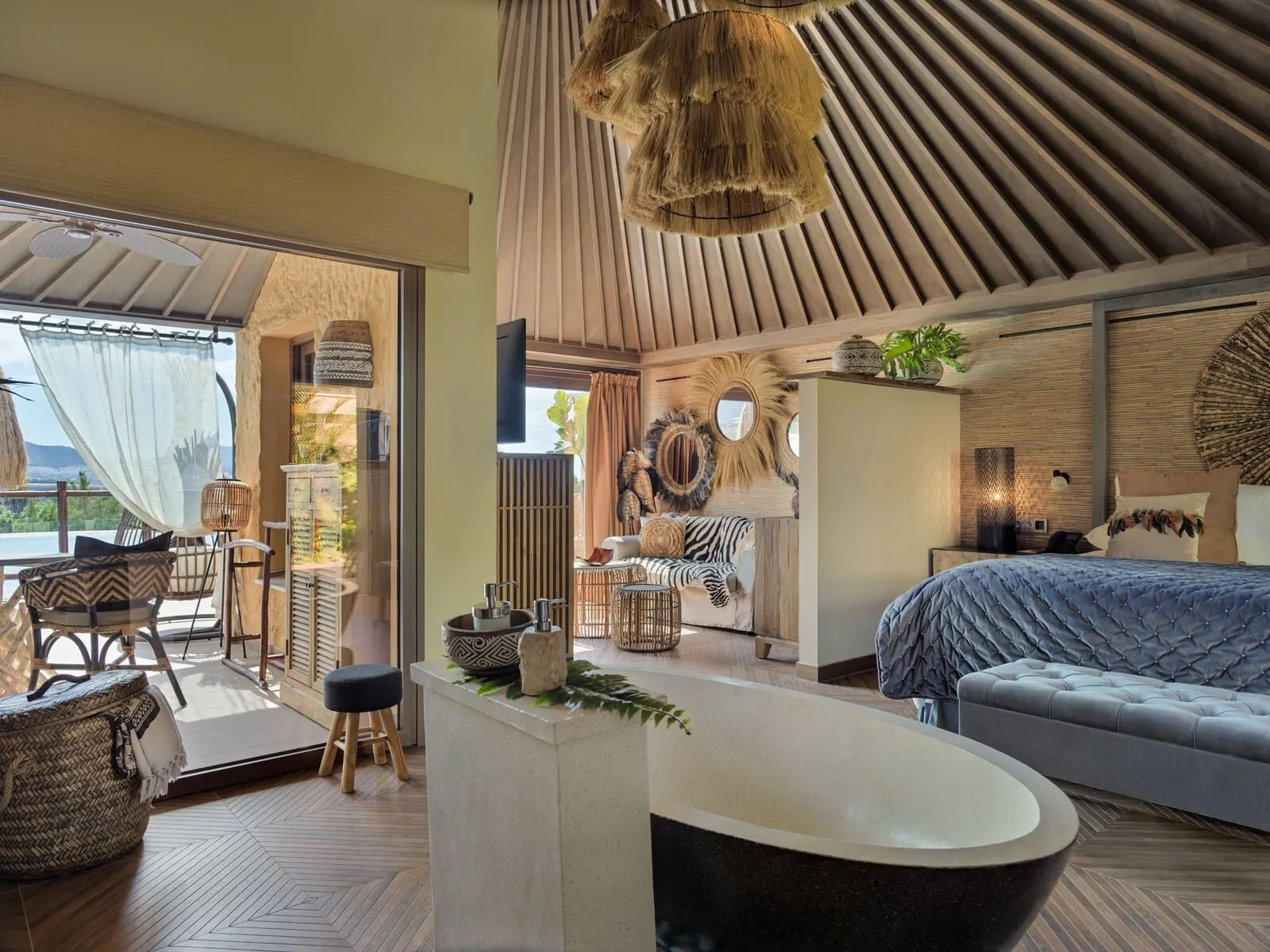 Royal River: A modern, well-lit room with a large bed, a seating area with a sofa and chairs