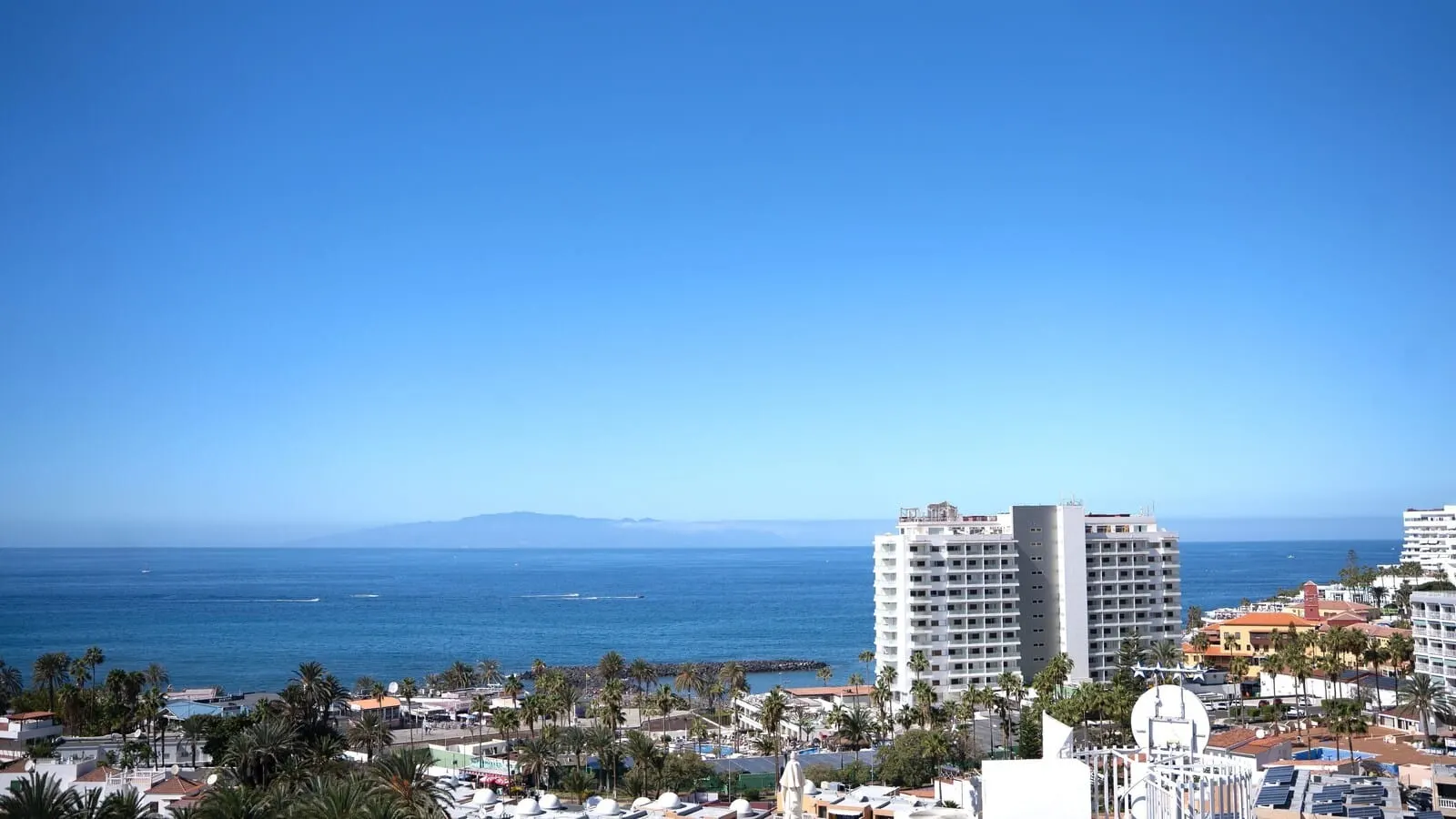 Coral Ocean View: A coastal cityscape with a prominent hotel featuring multiple floors