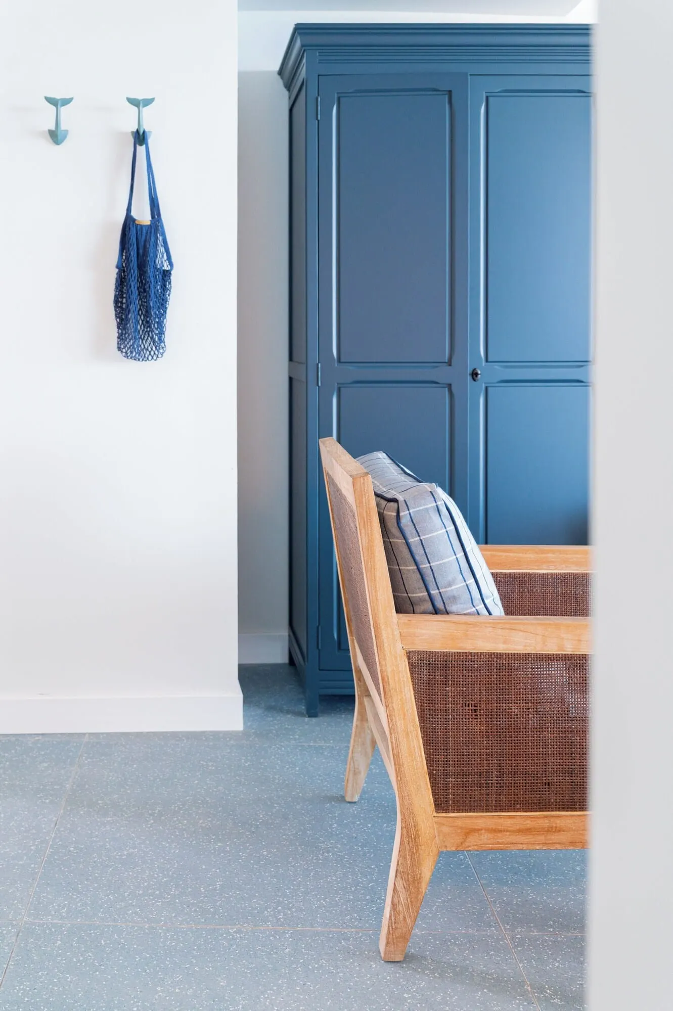 The Salmar: A room with a bed, a blue cabinet, and a hanging bag
