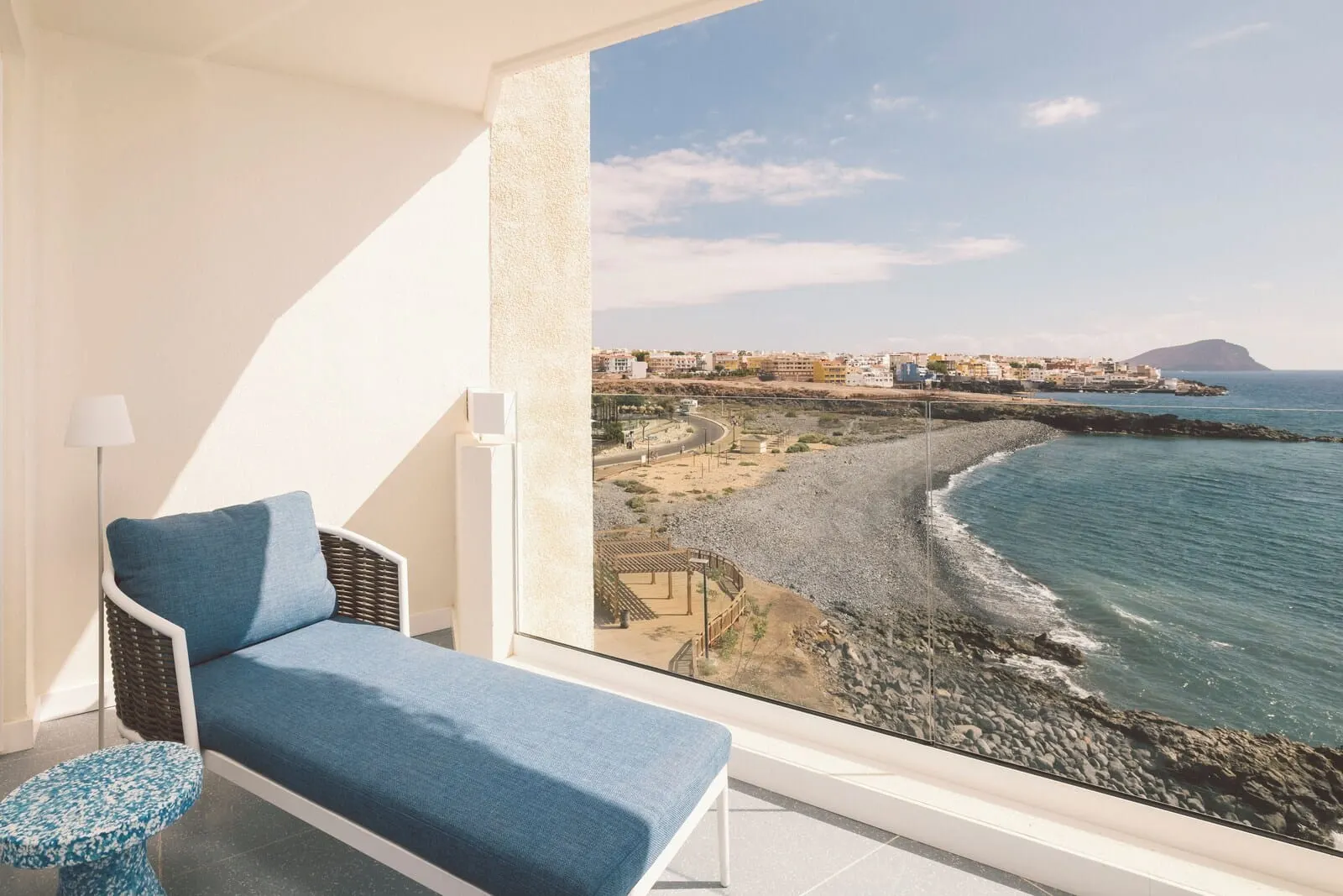 The Salmar: A balcony with a view of a beach and cityscape