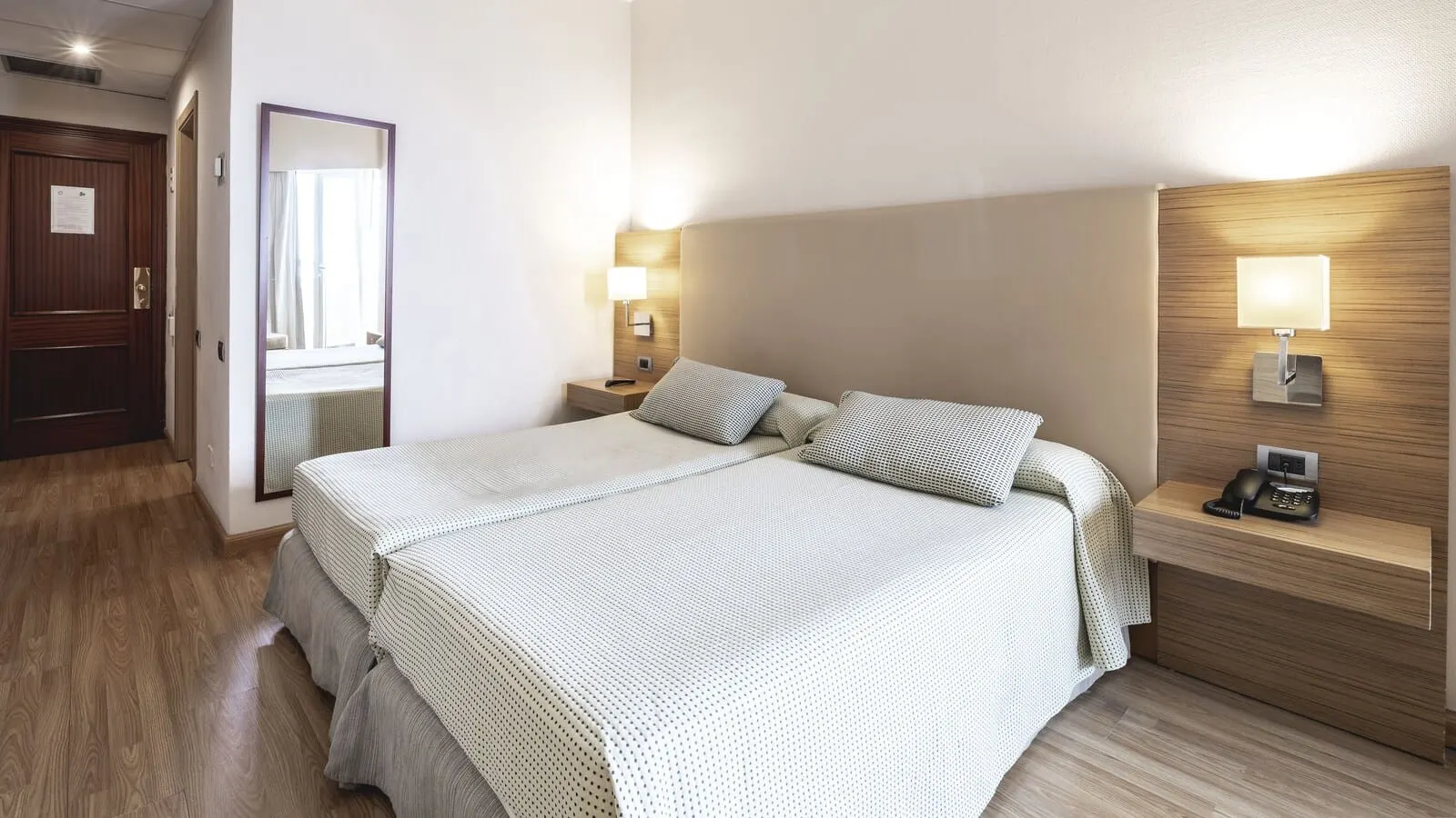 Be Live Adults Only Tenerife: A hotel room with a large bed, bedside lamps, a nightstand with a phone