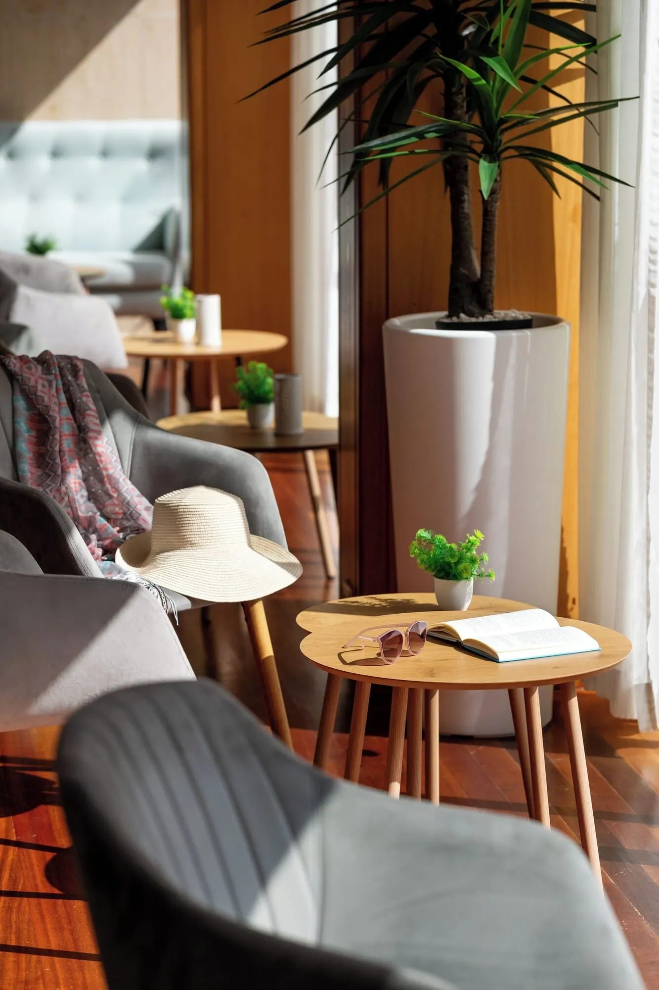 Hotel Don Manolito: A cozy seating area with a sofa, a chair, and a small table with a plant and a book