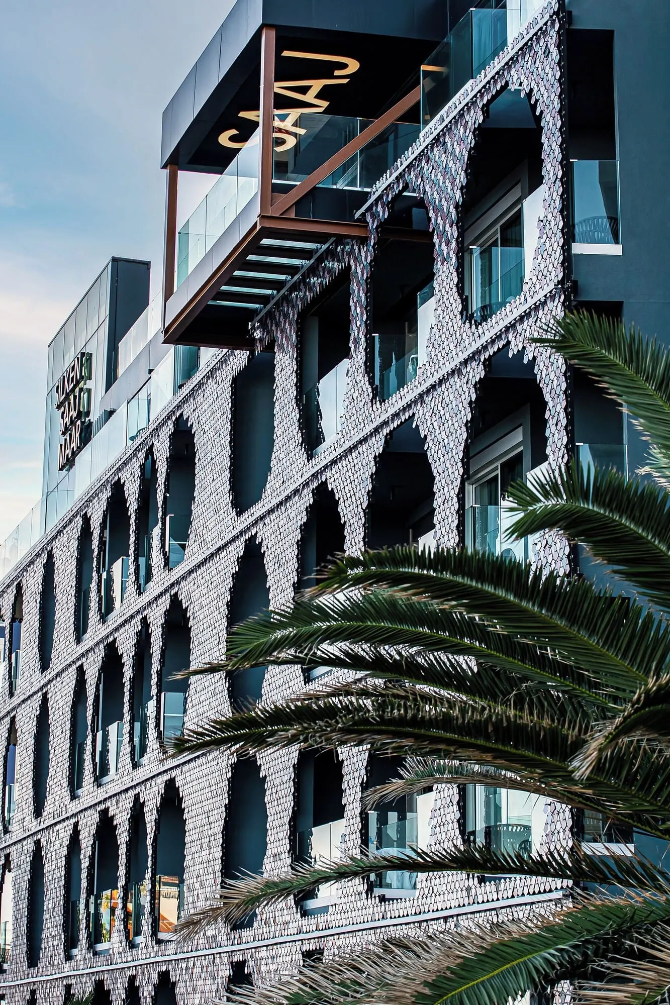 Silken Saaj Maar: A modern building with a distinctive facade featuring a patterned design and multiple