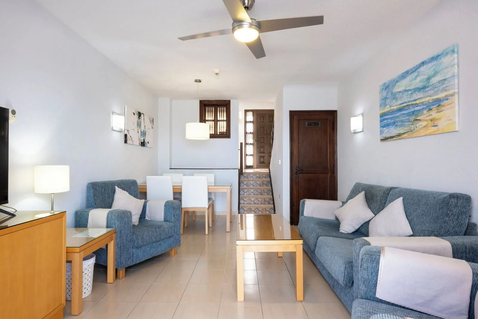Ona Las Rosas: A modern living room with a sofa, chairs, a coffee table