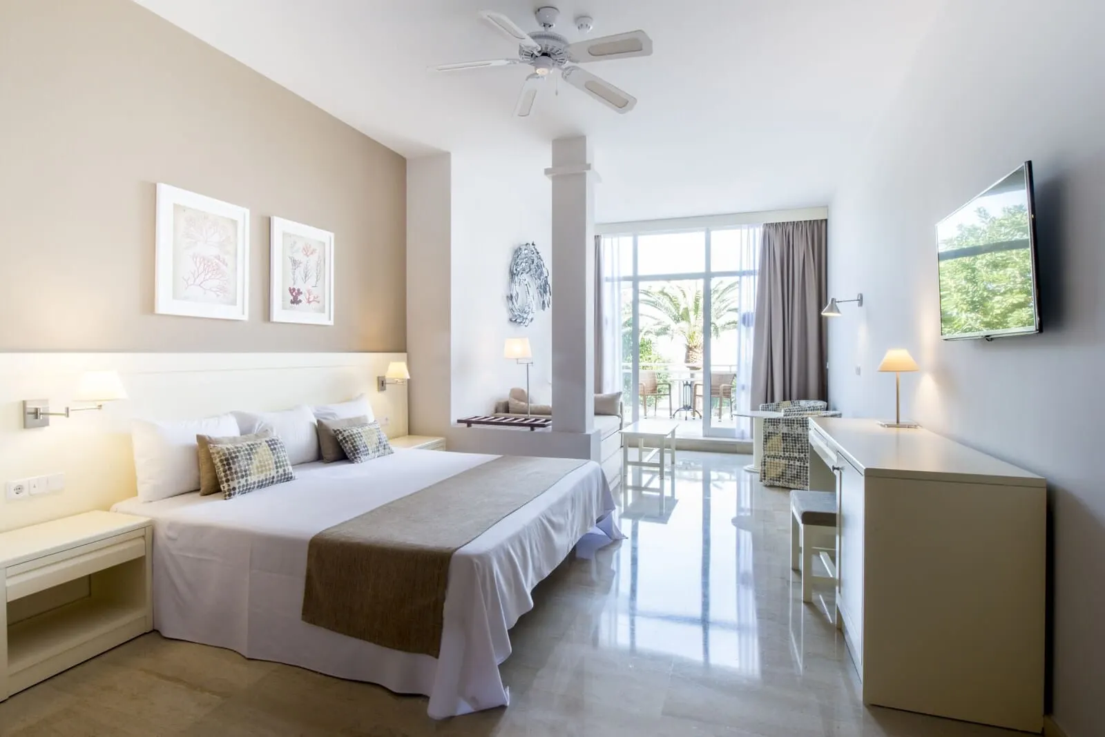 Bahia Principe Explore San Felipe: A hotel room with a large bed, a desk, a chair, a TV, and a balcony with a view