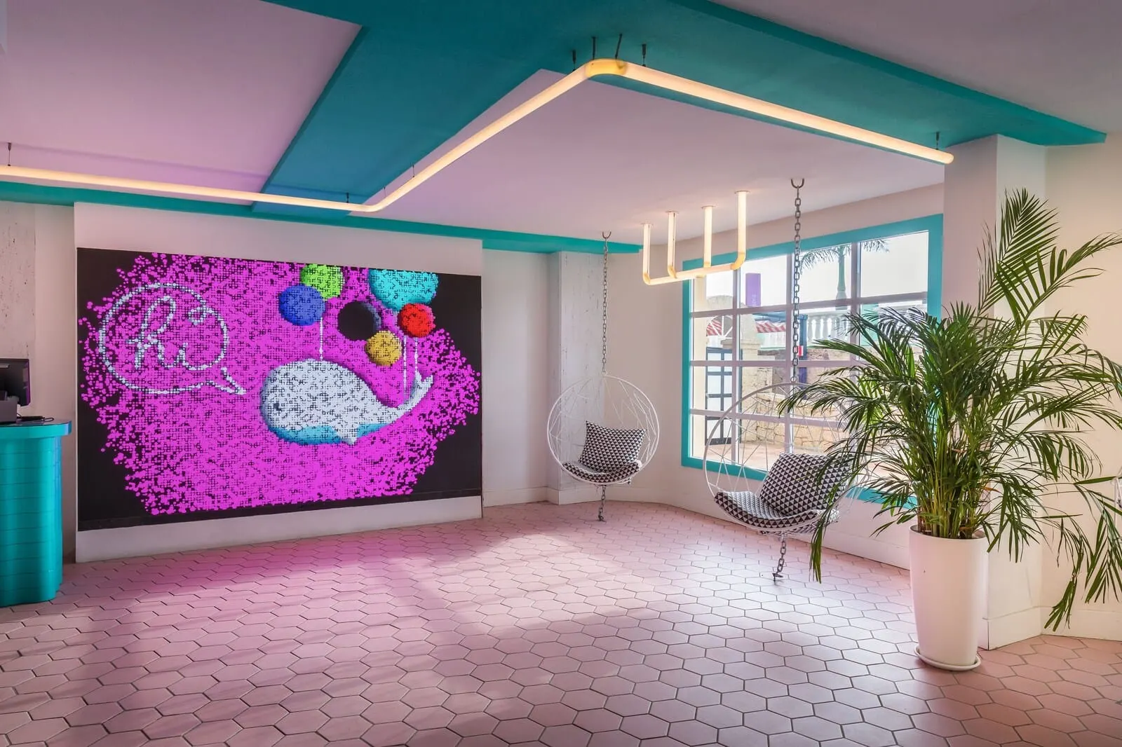 Servatur Isora Suites: A modern room with a colorful abstract mural, a hanging chair, a potted plant