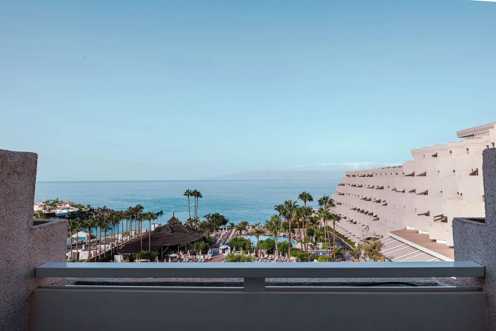 Landmar Playa la Arena: A resort with a pool, palm trees, and a view of the ocean