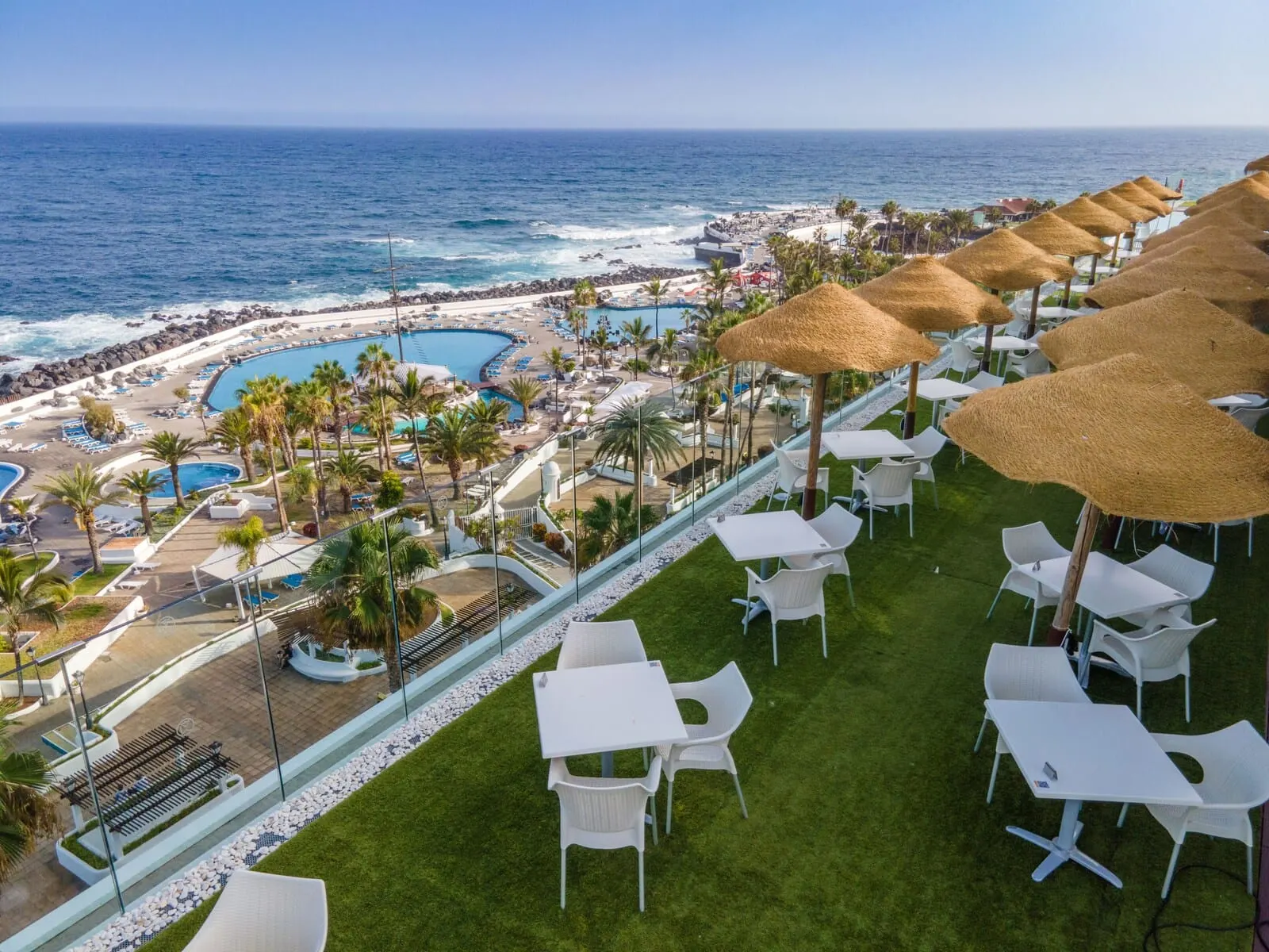Hotel Vallemar: A resort with a pool, beach, and thatched umbrellas