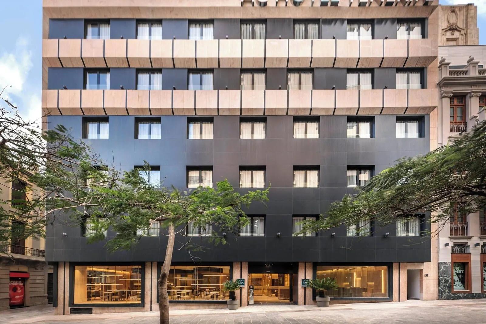AC Hotel Tenerife: A modern hotel with a symmetrical facade, large windows, and a central entrance