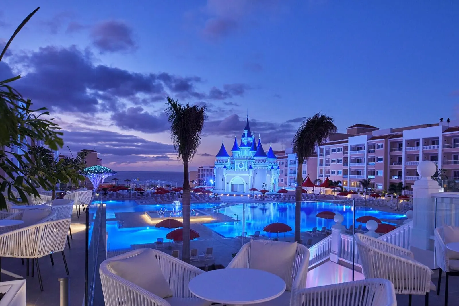 Bahia Principe Explore Fantasia: A hotel pool area with lounge chairs and umbrellas