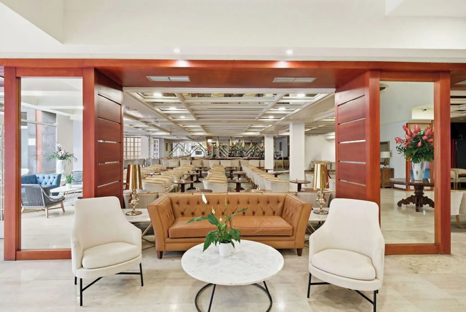 Bahia Principe Explore San Felipe: A spacious lobby with a central seating area featuring a brown sofa and two armchairs