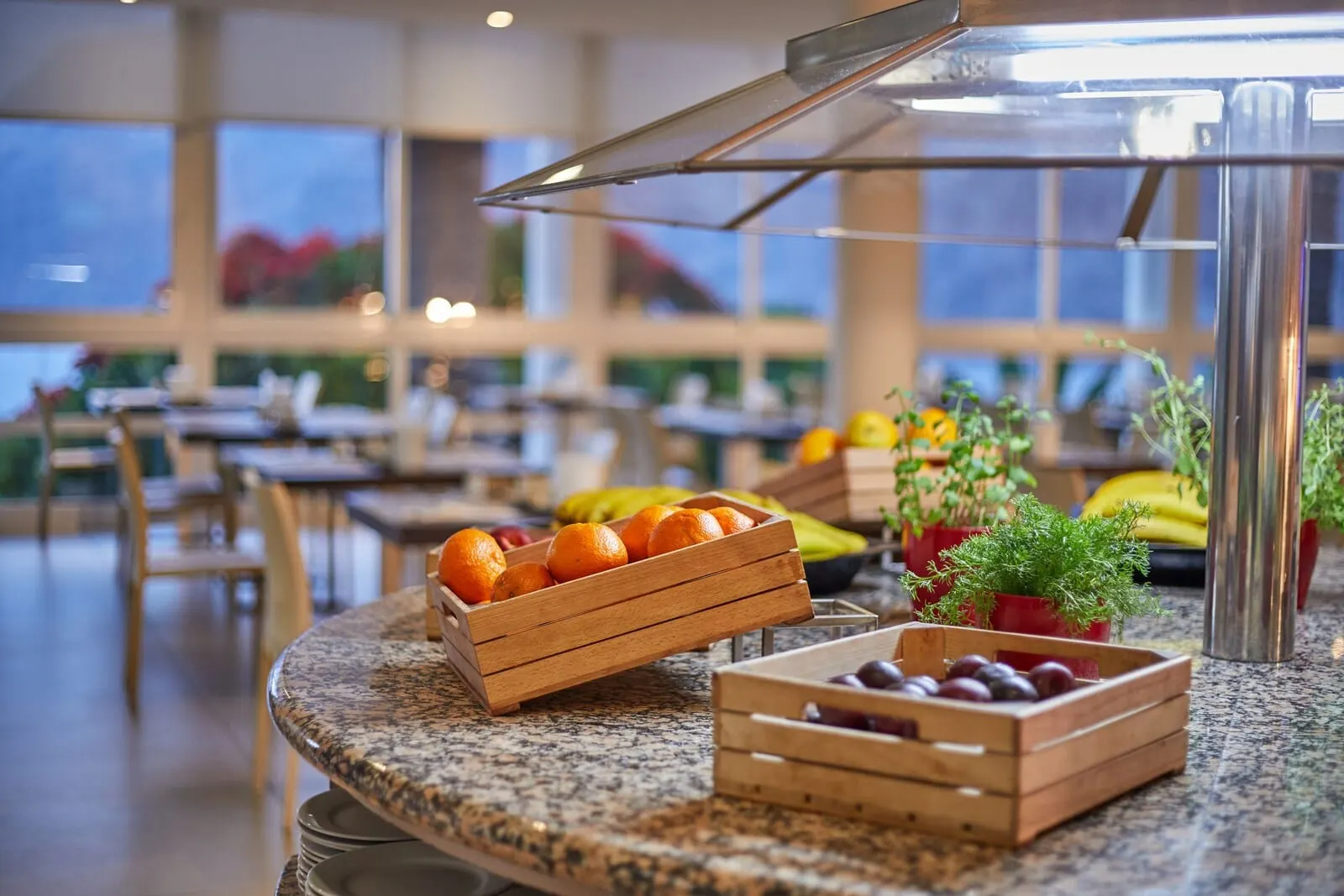 TUI Blue Los Gigantes: A breakfast buffet with wooden crates of fruits and a modern kitchen area