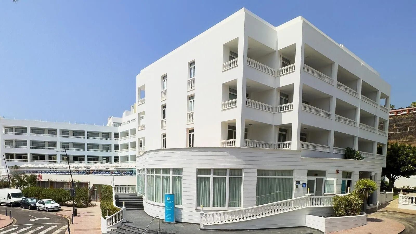 BlueSea Lagos de César: A multi-story hotel with balconies, a central staircase