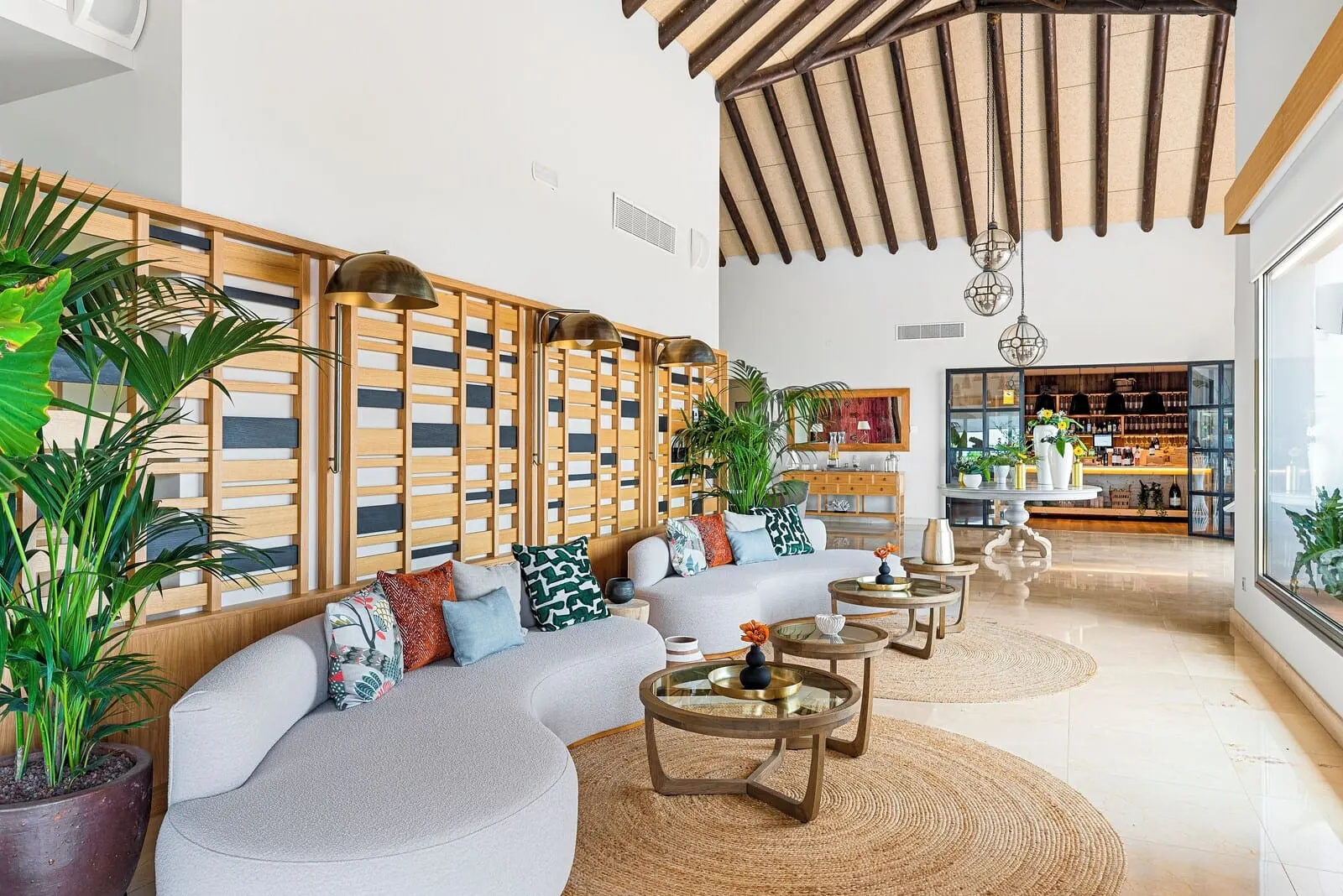 Las Terrazas de Abama Suites: A modern living room with a sectional sofa, round coffee tables