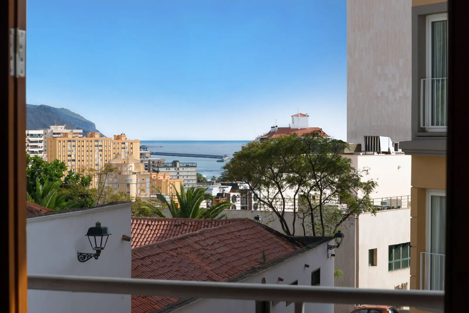 Iberostar Heritage Grand Mencey: A coastal cityscape with buildings, a clear sky, and a view of the sea