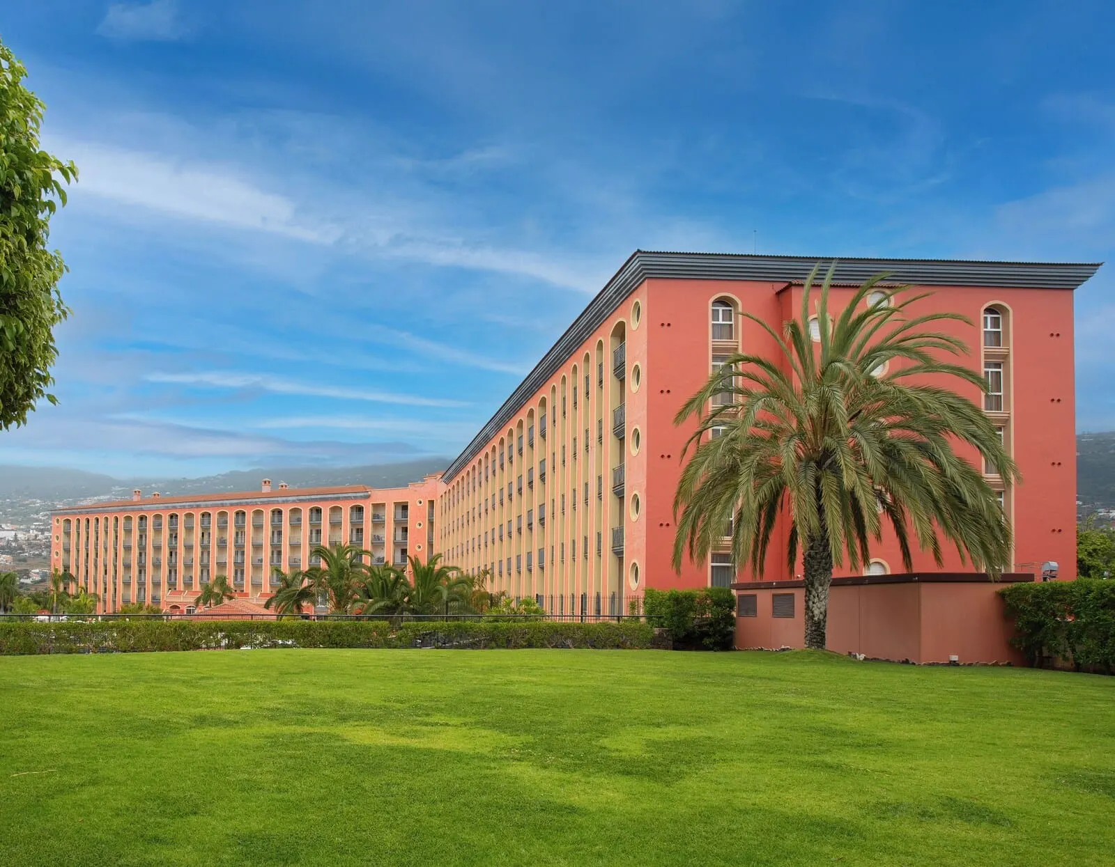 Hotel Las Águilas Tenerife, Affiliated by Meliá: A large building with a red facade, multiple balconies