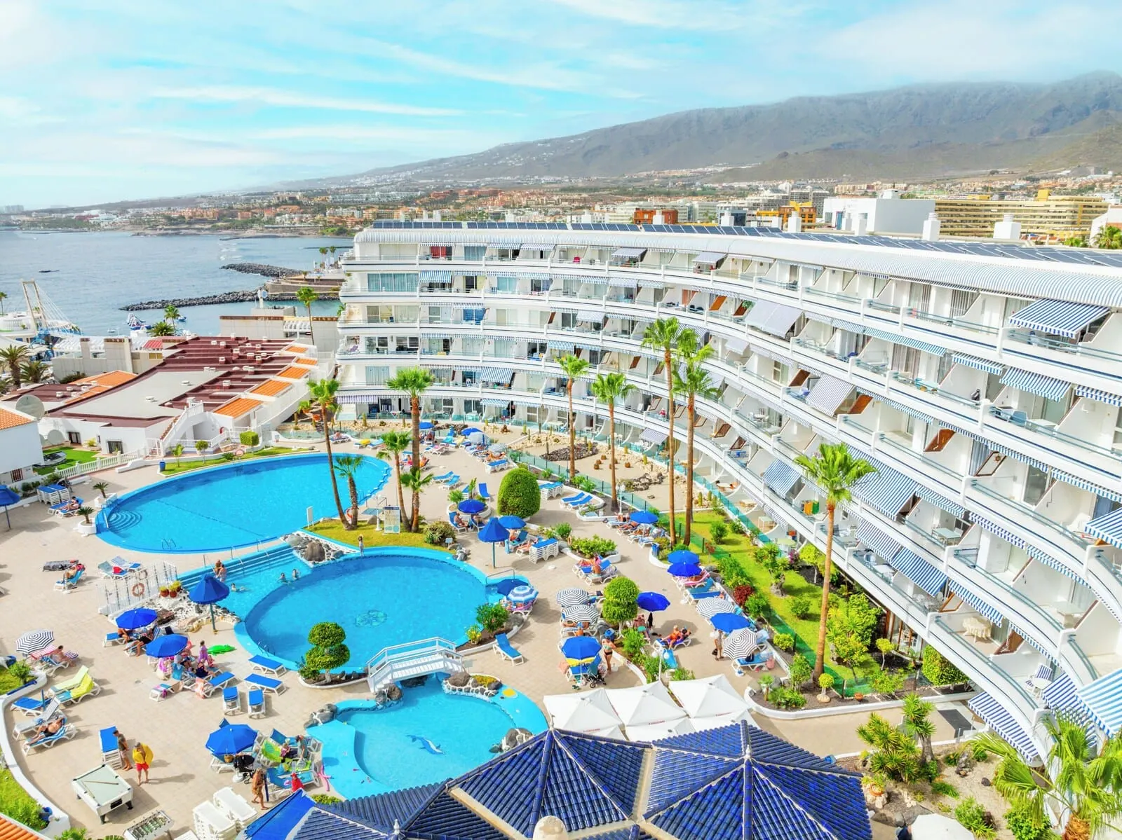 HOVIMA Atlantis: A resort with multiple swimming pools, sun loungers, and palm trees