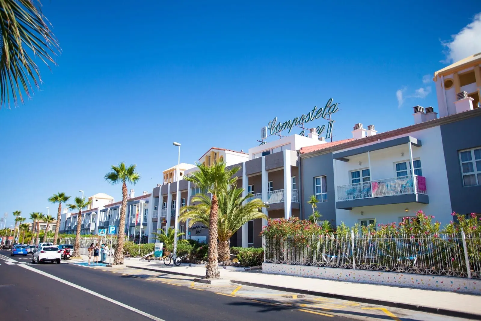 Coral Compostela Beach Golf: A multi-story hotel with balconies, palm trees, and a clear blue sky
