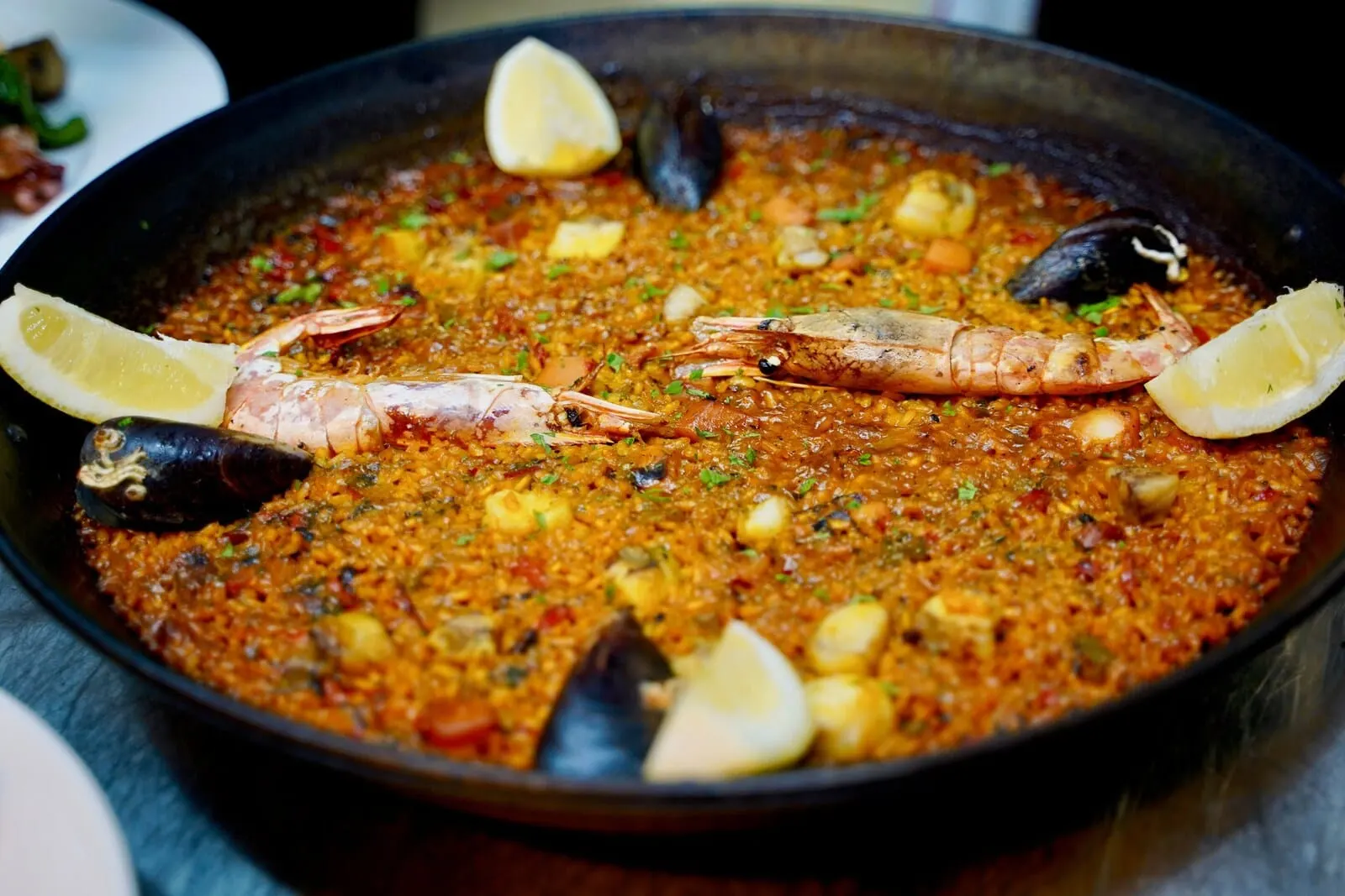 Playa Surf CBbC Hotel: A seafood paella with shrimp and mussels, garnished with lemon slices