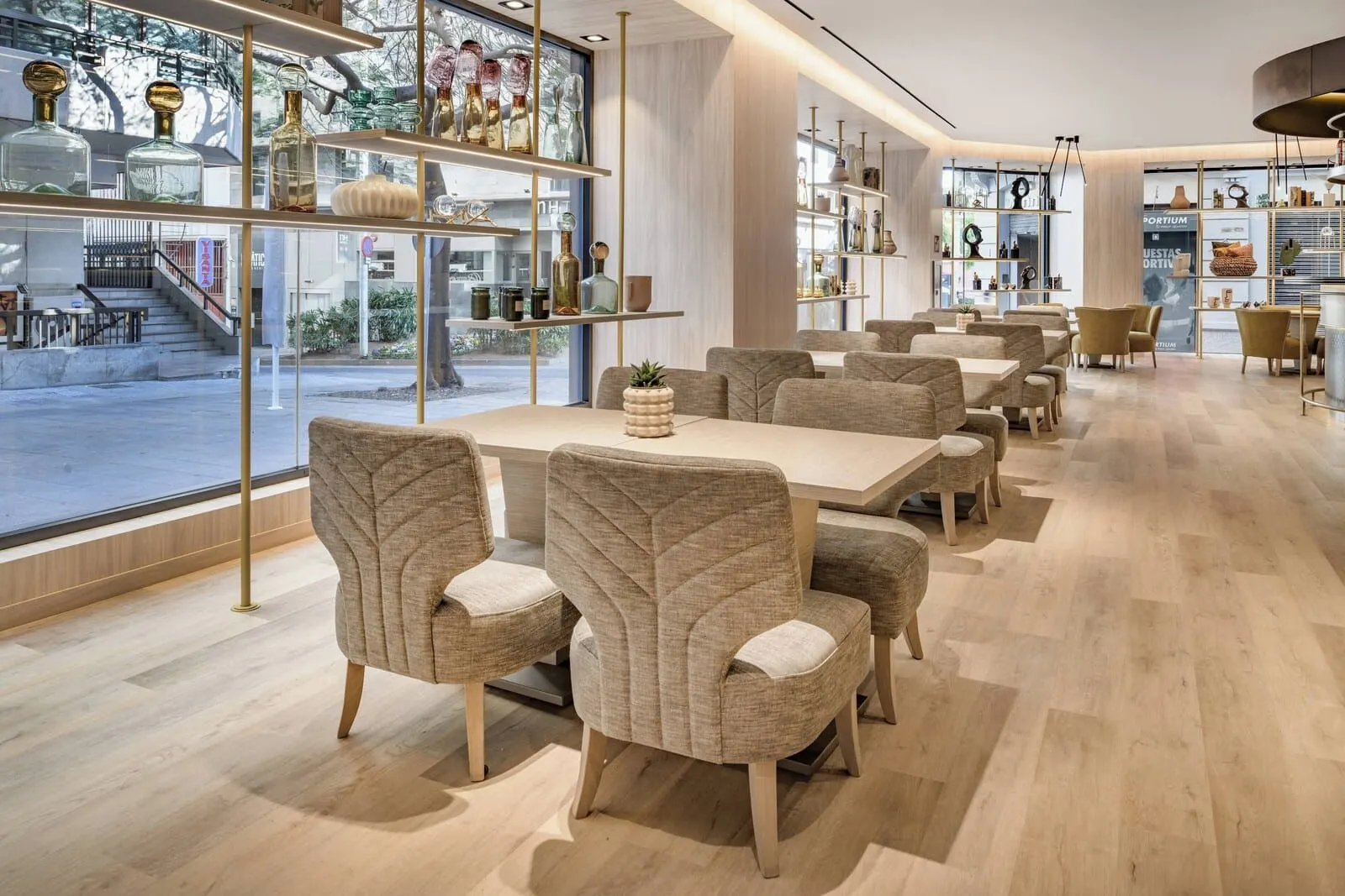AC Hotel Tenerife: A modern dining area with a long table and cushioned chairs