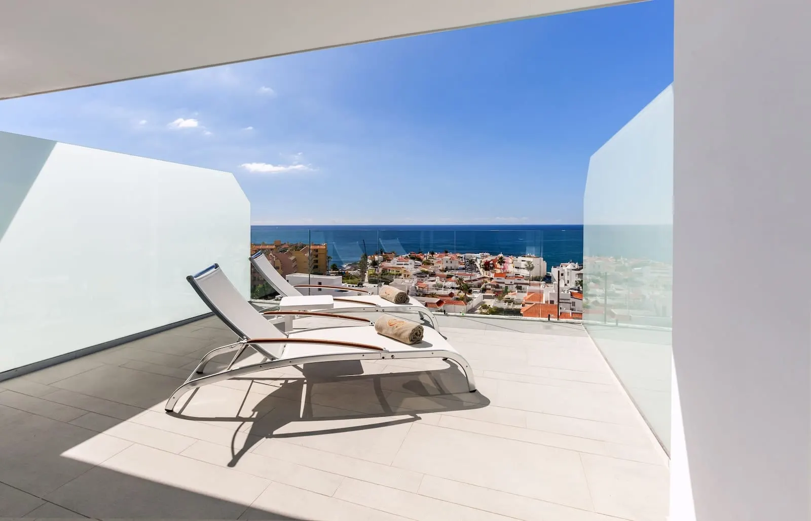 Royal Hideaway Corales Beach: A modern balcony with a clear view of the sea and a coastal town