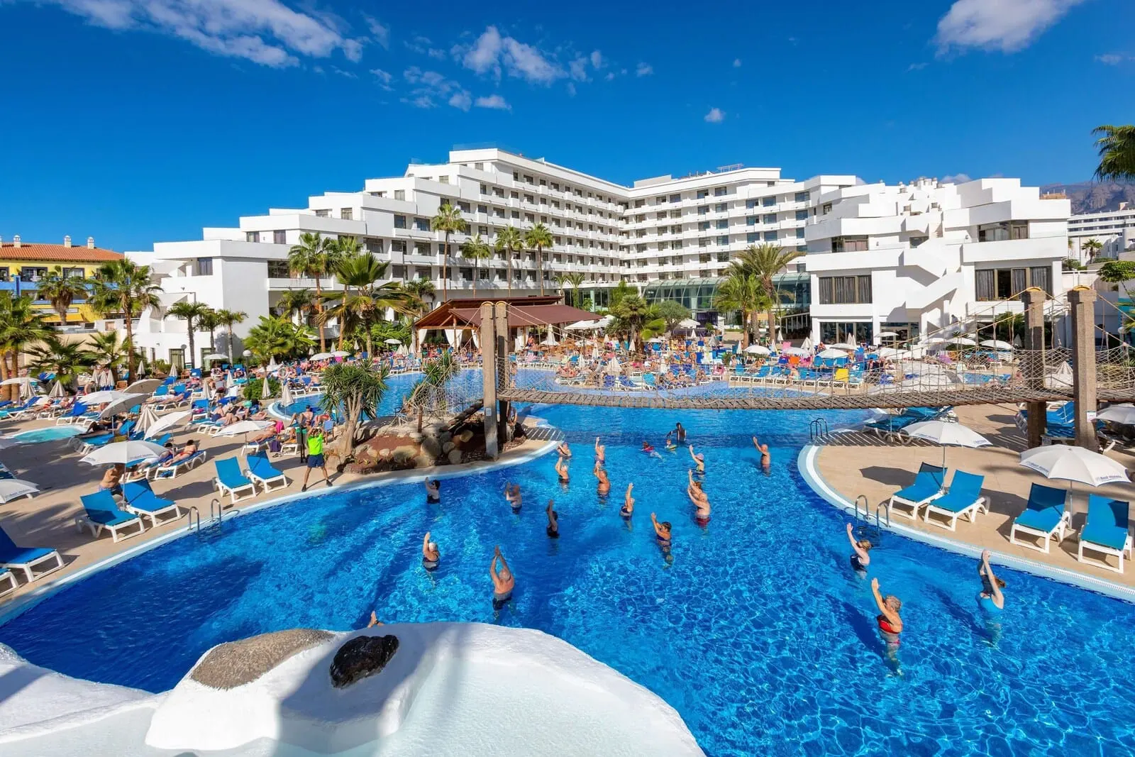 Best Tenerife: A large outdoor swimming pool surrounded by lounge chairs and umbrellas
