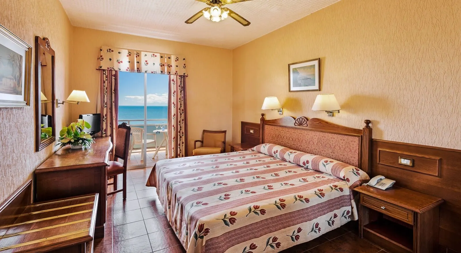 Hotel Monopol: A hotel room with a bed, a desk, a chair, a small table with a plant