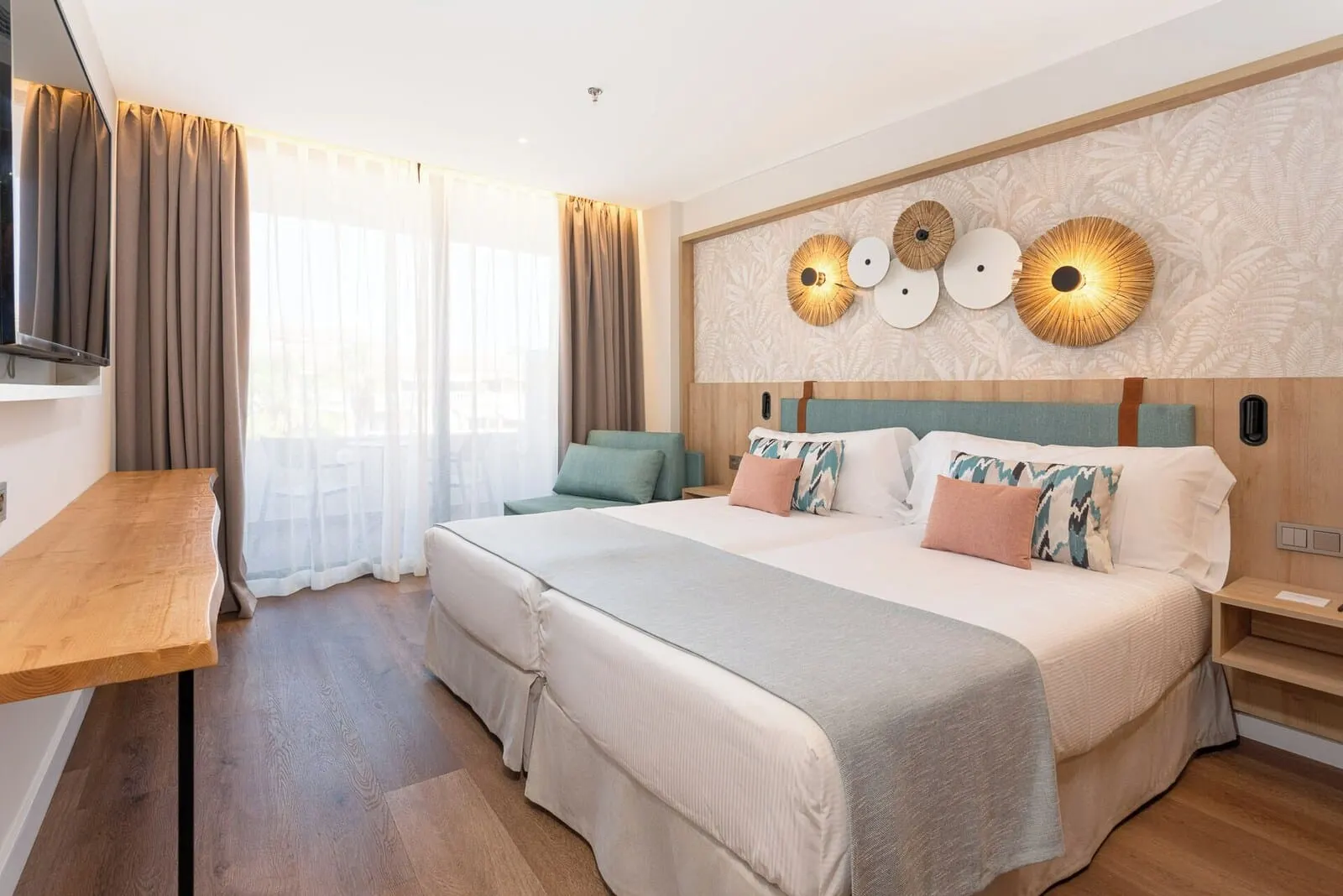 Mediterranean Palace: A modern hotel room with a large bed, a wooden desk, and a TV