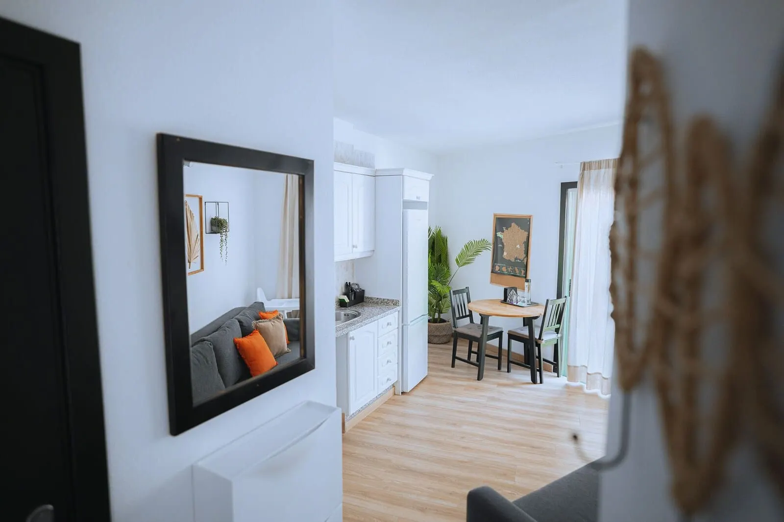 Hotel Ventus: A modern kitchen with white cabinets, a dining area with a wooden table and chairs