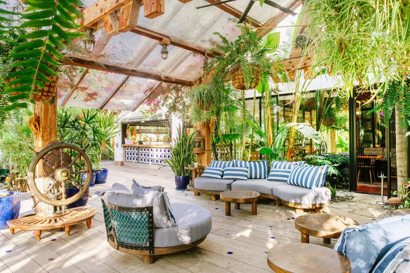 Parque Santiago III: A covered outdoor seating area with sofas, tables, and hanging plants