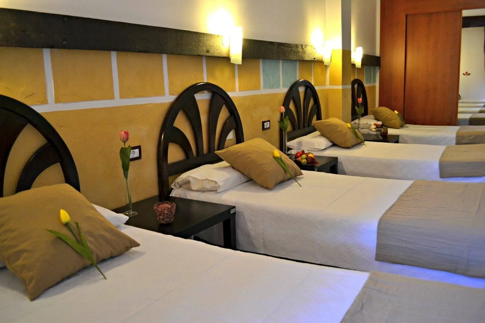 4Dreams Hotel: A hotel room with multiple beds, each with a wooden headboard, white bedding