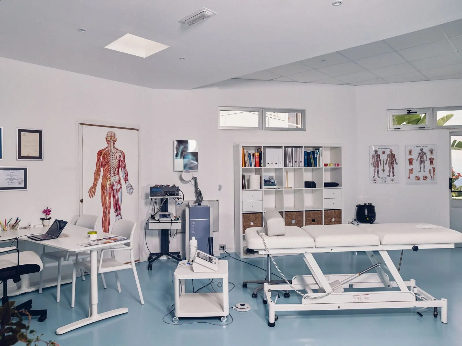 Route Active Hotel: A clinical examination room with medical posters, a computer