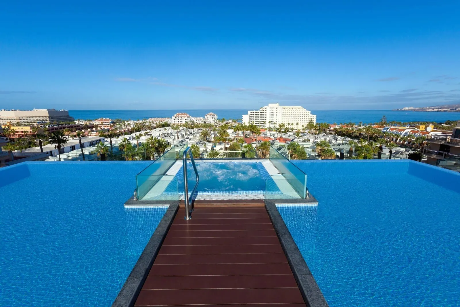 Tigotan Lovers & Friends: An infinity pool with a glass edge, leading to a beach view