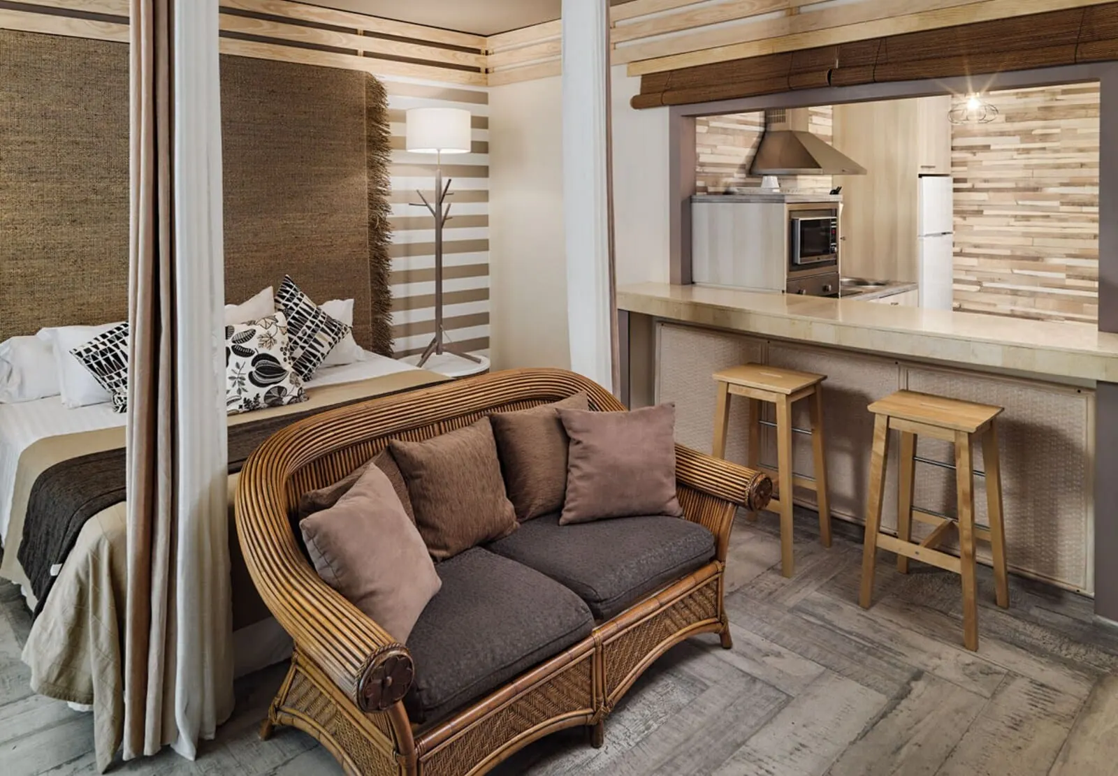 Green Garden Eco Resort & Villas: A modern bedroom with a large bed, a wicker sofa