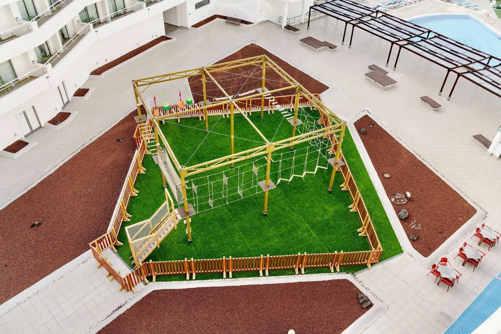 Alua Atlántico Golf Resort: An indoor playground with a climbing structure, seating areas, and a pool