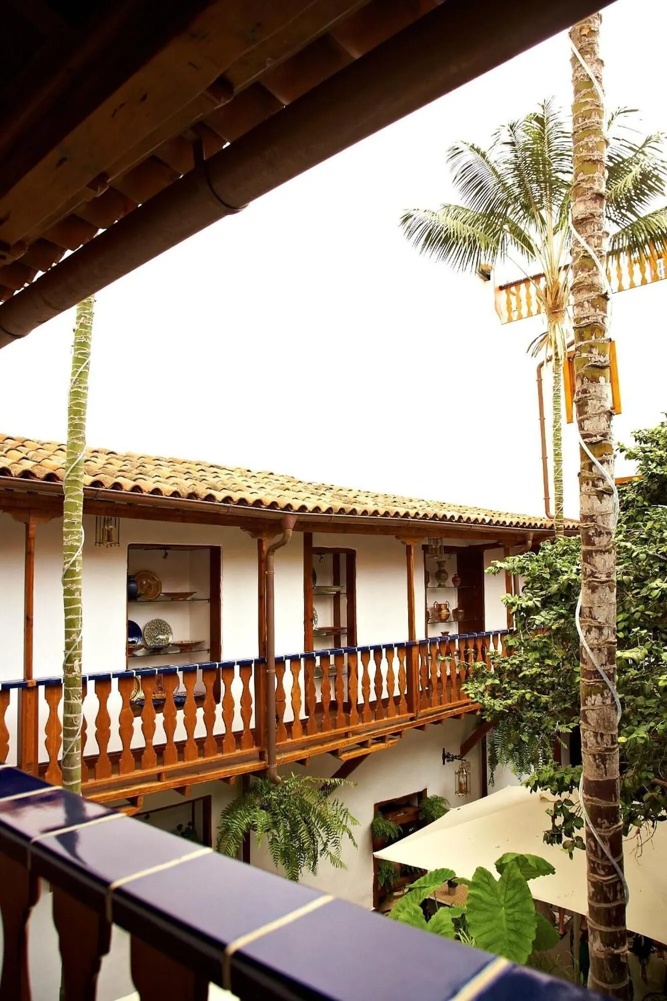 Hotel Emblemático San Agustín: A traditional building with a tiled roof and wooden balconies