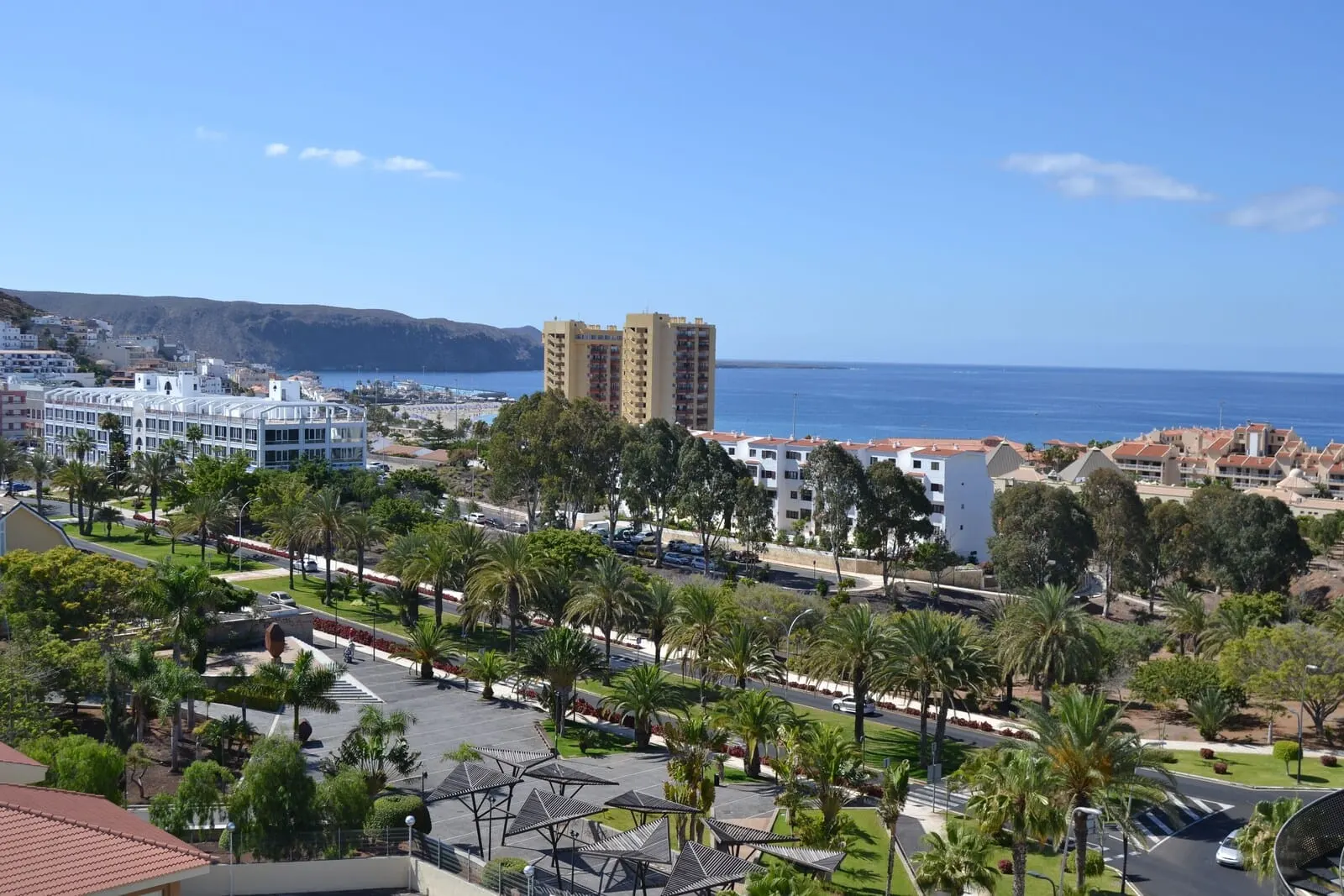 Hotel Zentral Center: A coastal cityscape with modern buildings, a marina, and a clear blue sky