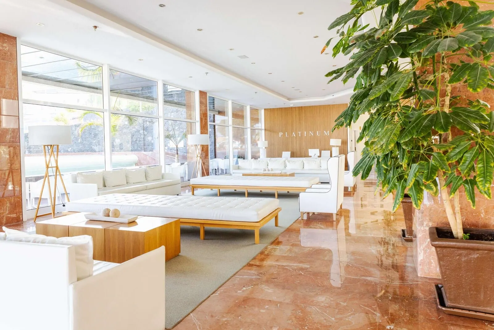 Landmar Playa la Arena: A modern hotel room with large windows, a bed, a sofa, and a coffee table