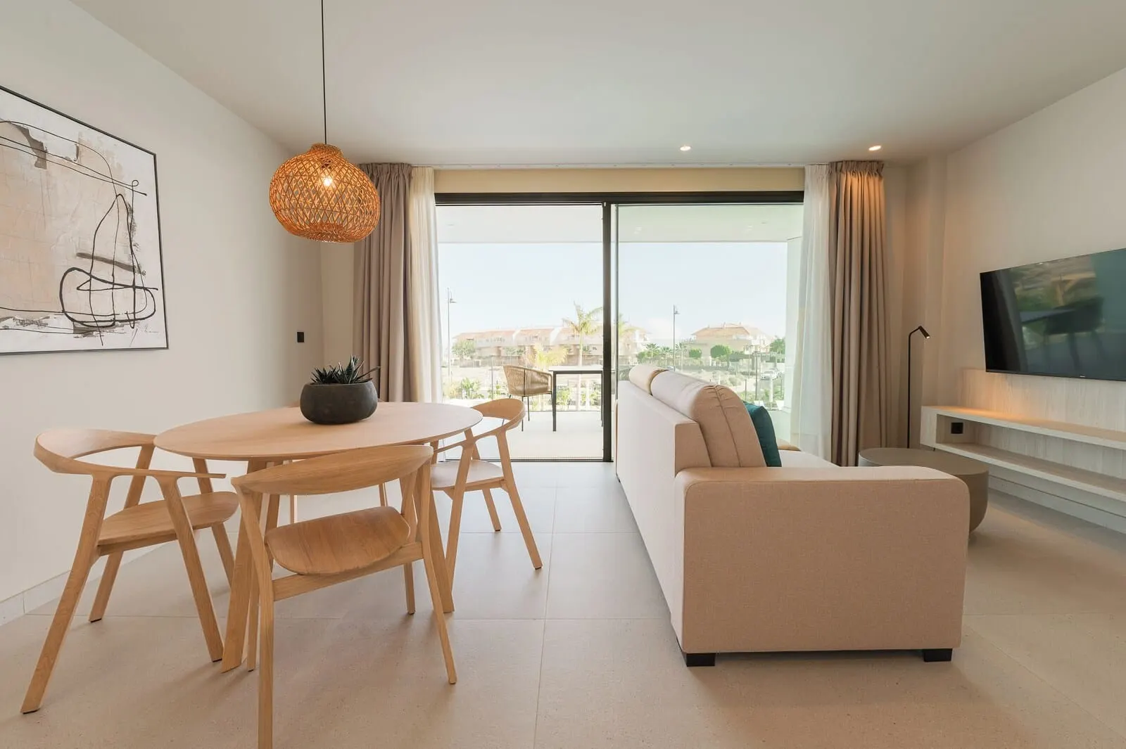 Amarilla Golf Residences: A modern living room with a sofa, a dining table with chairs, a hanging light fixture