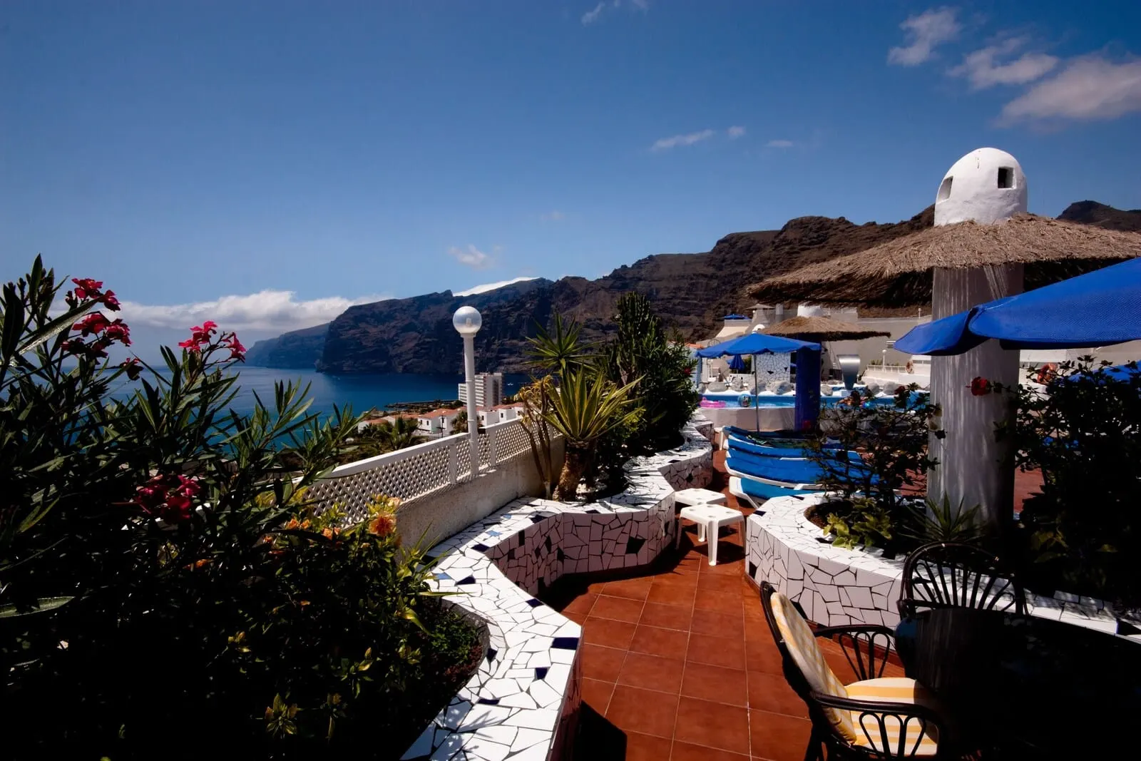 Vigilia Park: A rooftop terrace with a pool, outdoor seating, and a view of the sea