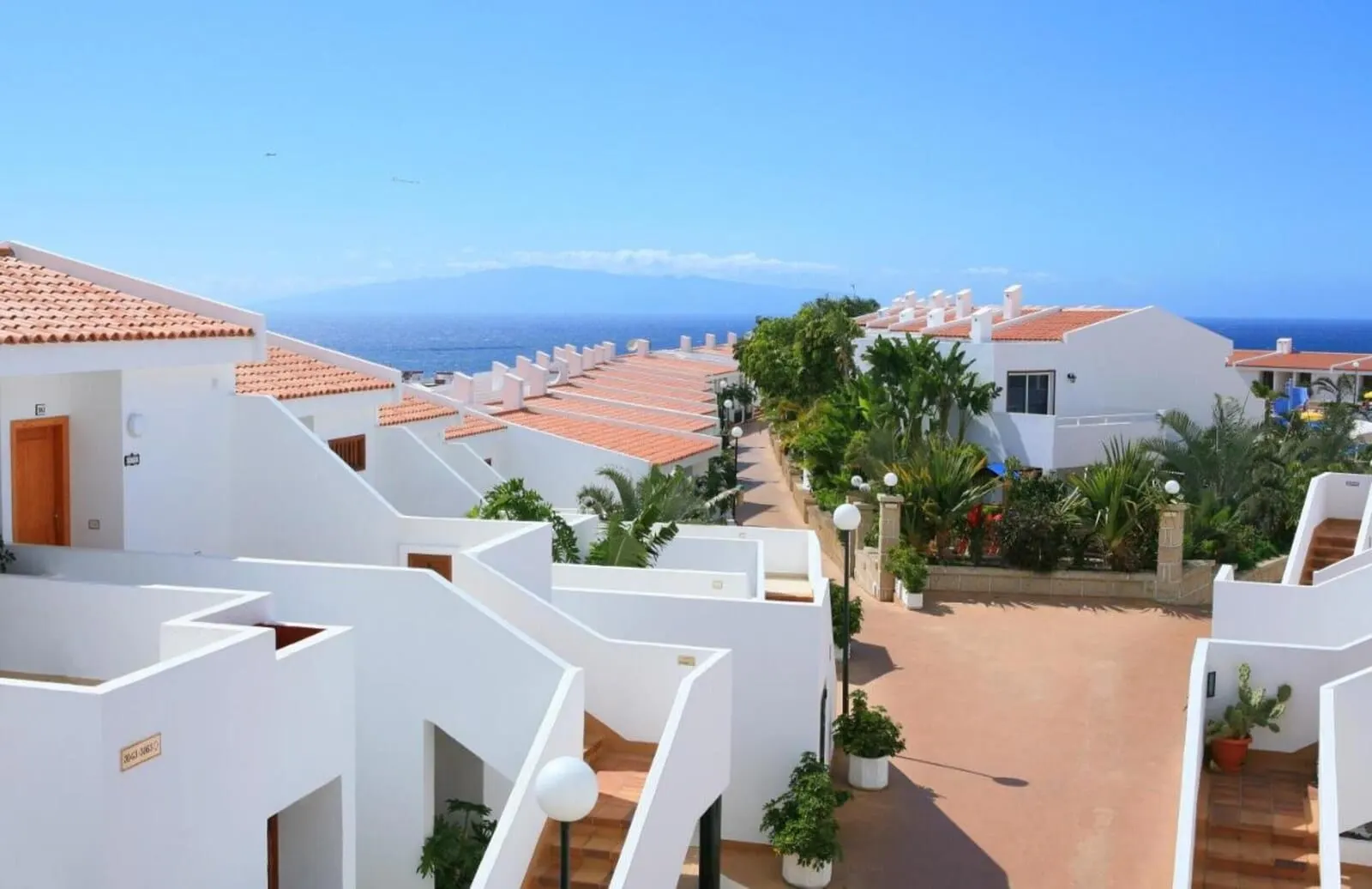 Malibu Park: A coastal hotel with white buildings, terracotta roofs, and a view of the sea