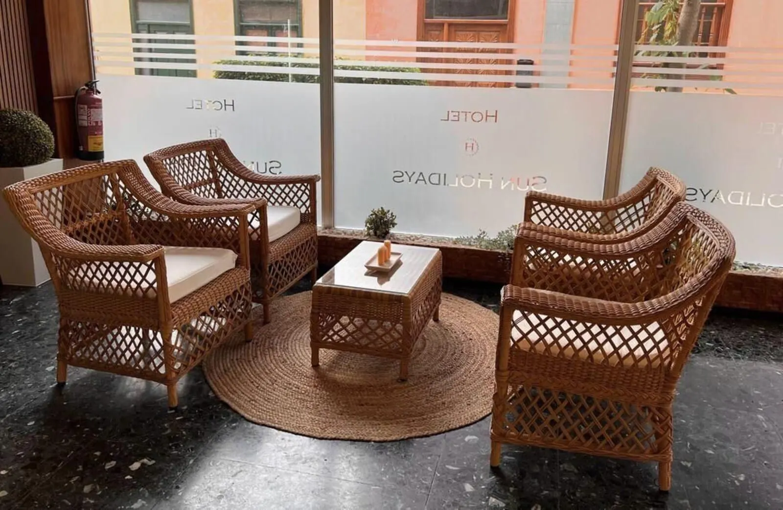 Hotel Sun Holidays: Wicker furniture with cushions and a woven rug in a hotel lobby