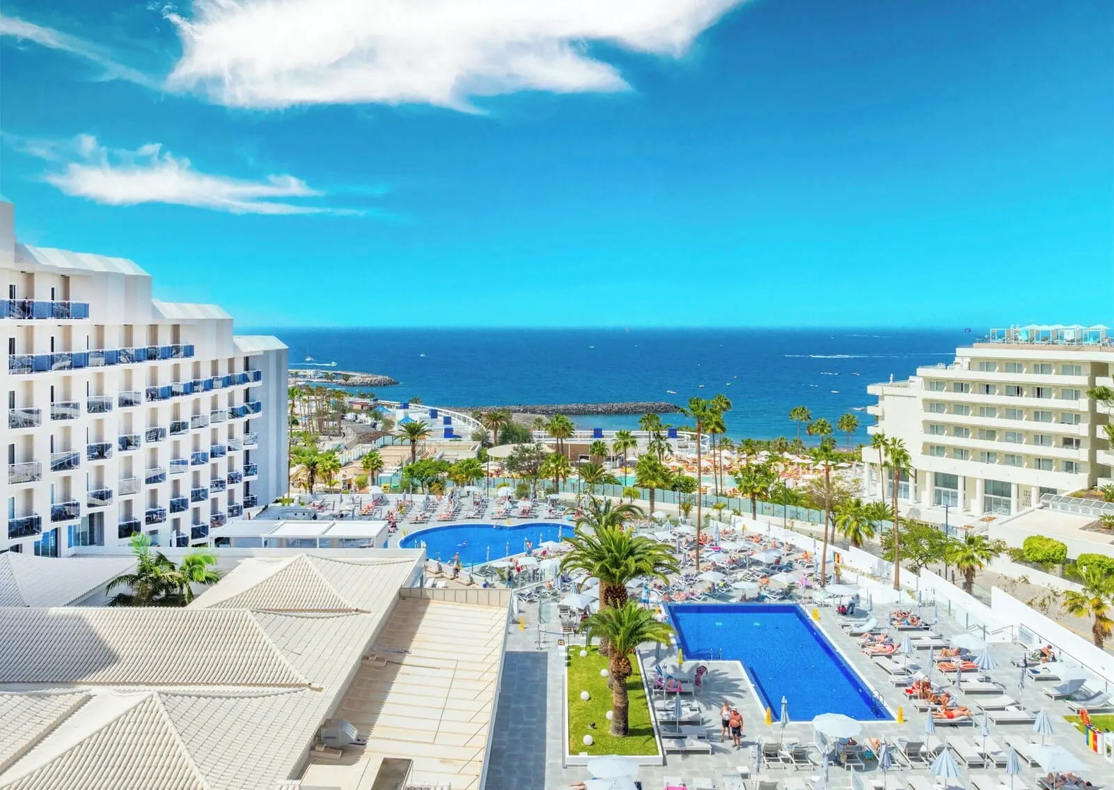 HOVIMA Cool Costa Adeje: A resort with a large pool, multiple balconies, and a view of the ocean