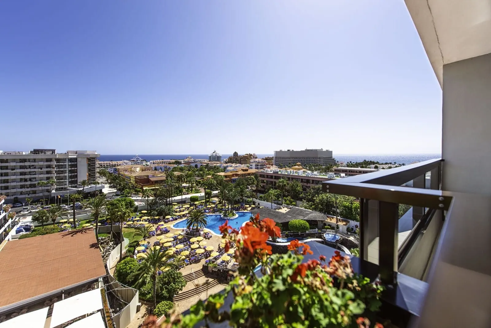 Spring Hotel Bitácora: A resort with a pool area, palm trees, and a view of the ocean