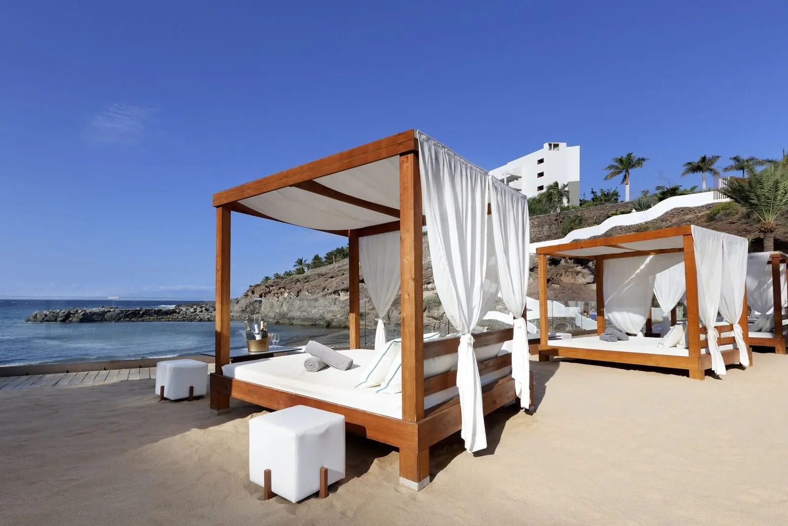 Hard Rock Hotel Tenerife: A beachside hotel with wooden canopy beds, white linens