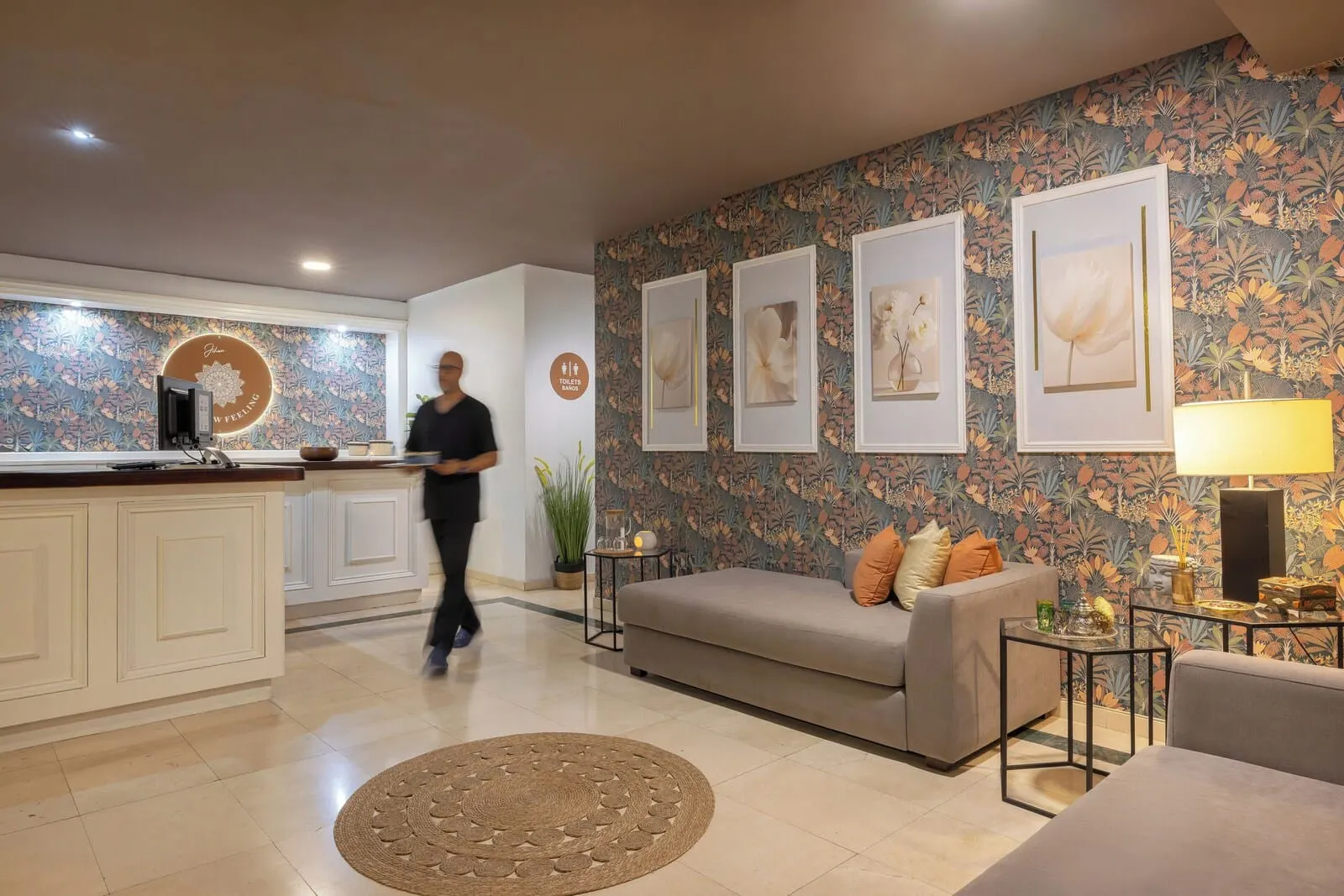 AluaSoul Costa Adeje: A modern living area with a sofa, a coffee table, and framed artwork on the wall