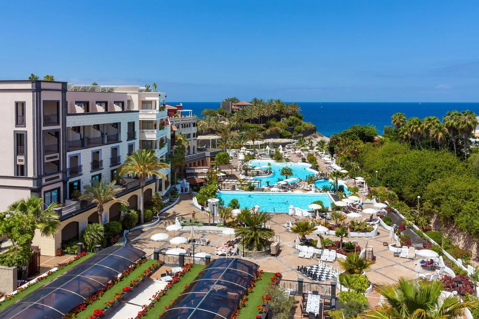 Gran Tacande Wellness & Relax: A resort with multiple swimming pools, outdoor seating areas, and a view of the ocean