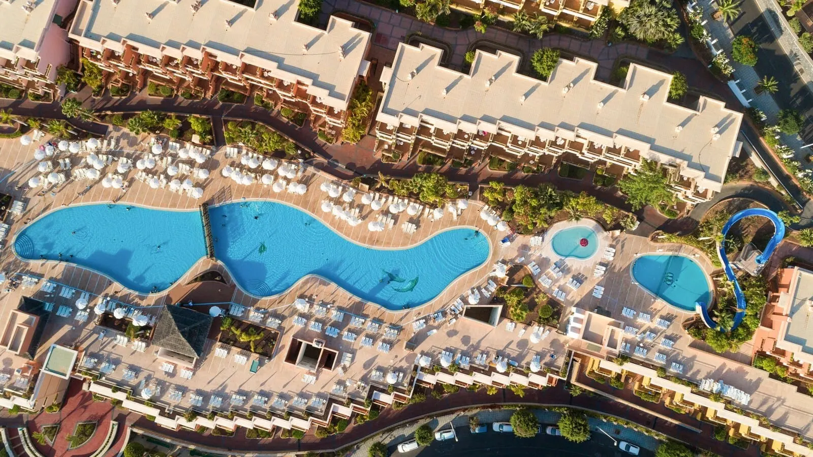 Landmar Costa Los Gigantes: An aerial view of a resort with multiple swimming pools, sun loungers